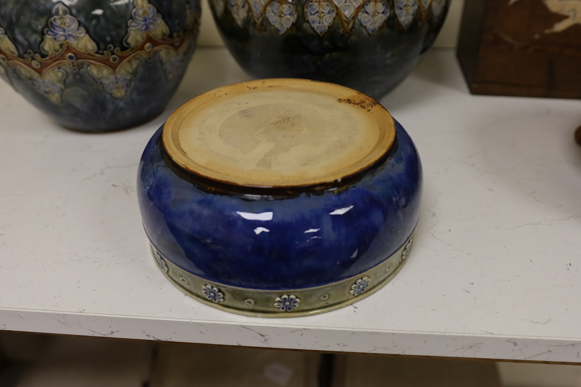 Two Royal Doulton early 20th century stoneware jardinieres and a similar stoneware bowl, tallest jardiniere 22cm high. Condition - frilled edge jardiniere chipped